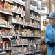 Queen Elizabeth II looks at products on the shelves at a Waitrose supermarket during a visit to the town of Poundbury on October 27, 2016 in Poundbury, Dorset. Photo via Getty Images.